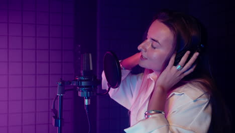 female singer recording in a studio