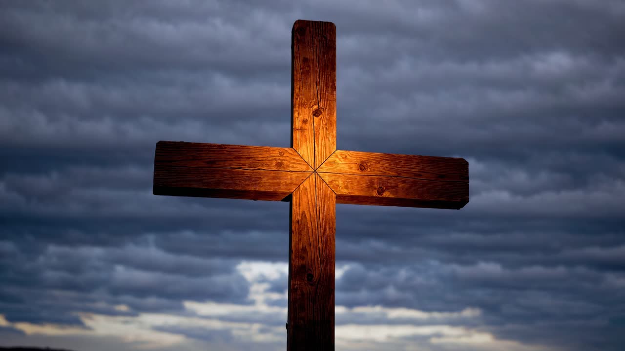 A dramatic black and white video featuring a wooden cross against a cloudy sky, captured from a low