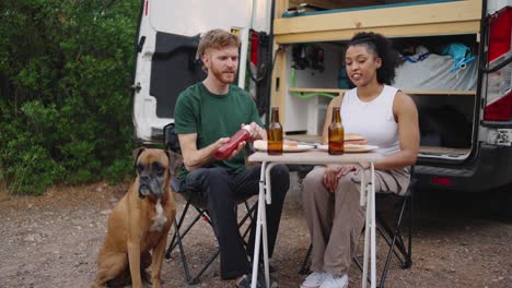 couple enjoying a meal with their dog during a van life adventure