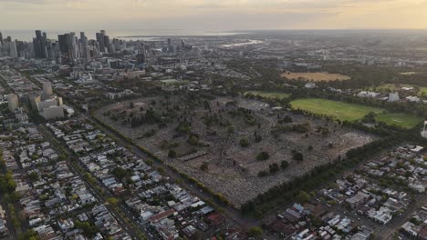 aerial view of a large cemetery and urban landscape with city skyline