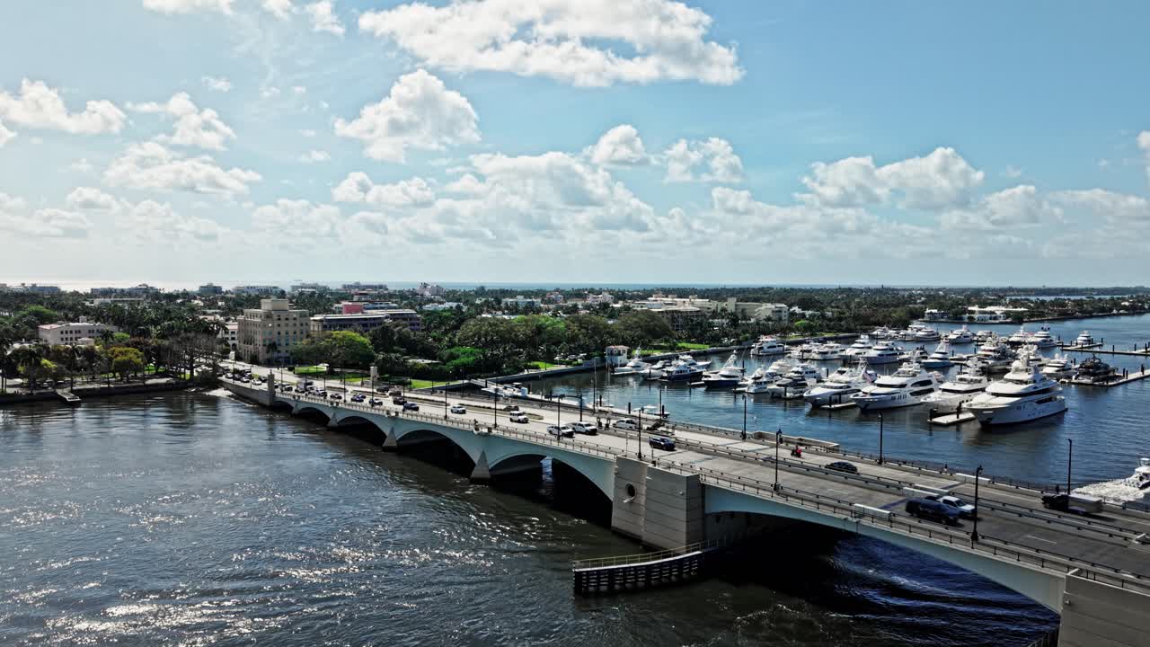 Crane up drone shot of Royal Park Bridge with yachts during the day in West Palm Beach, Florida, USA