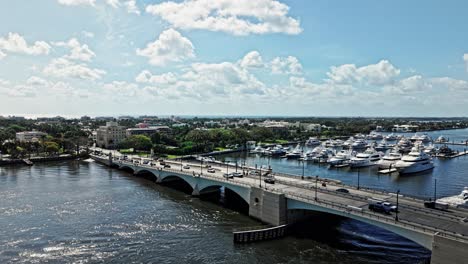 crane up drone shot of royal park bridge with yachts during the day in west palm beach, florida, usa
