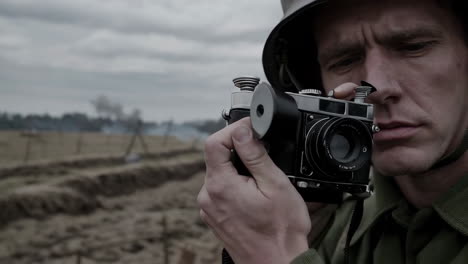 wwii soldier taking pictures on the battlefield