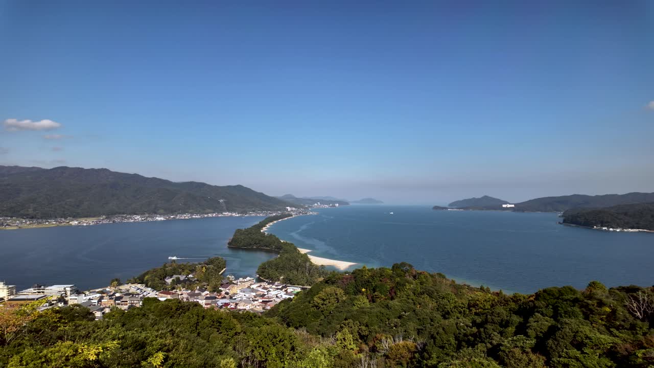 Scenic view of Amanohashidate, one of Japan's three scenic views, a pine covered sandbar dividing Miyazu Bay. pan right