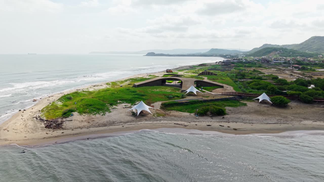 Slow motion aerial view of a beautiful tropical beach with star-shaped gazebos, salinas de rey, colombia
