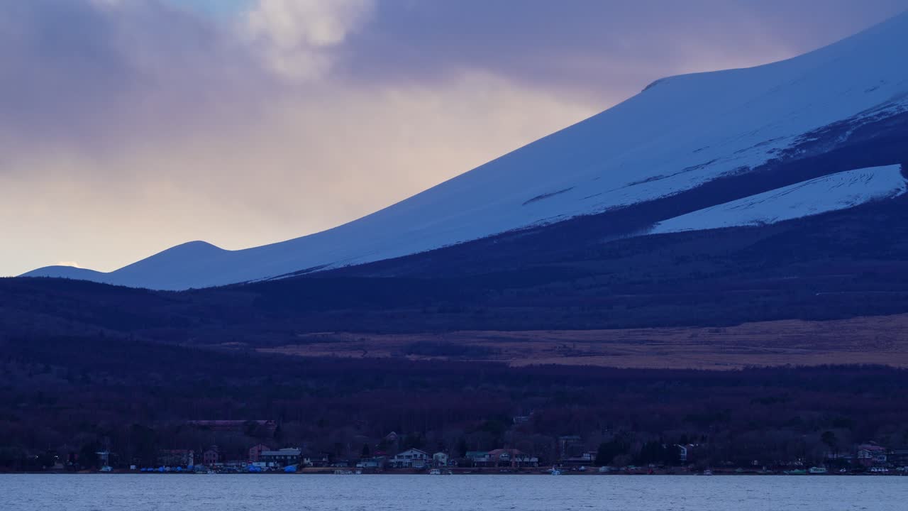 Snow-blanketed slope of Mount Fuji in close-up view, capturing the iconic Japanese landmark in wintertime