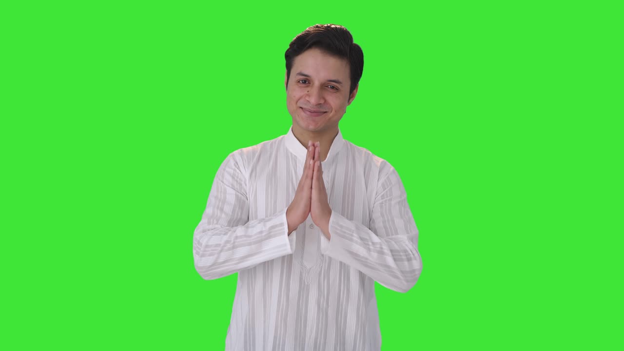 Happy Indian man doing Namaste Green screen