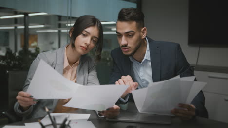 business colleagues discussing documents in an office meeting