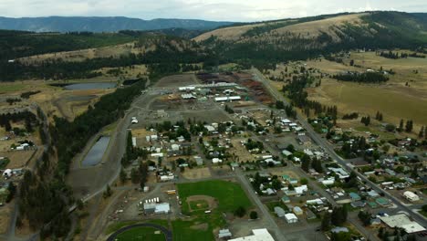 US, Oregon, Elgin, 2025-08-07 - Drone view of the Boise Cascade Plywood Mill with the High School in the foreground