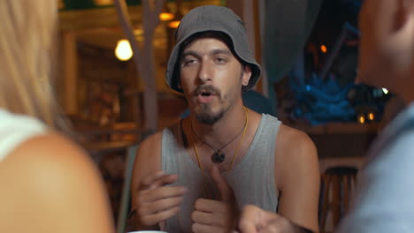 man proposing a toast during friends gathering in cafe