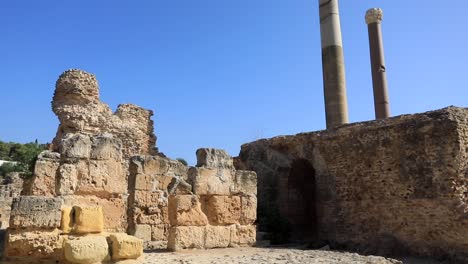 ancient roman columns against clear blue sky in carthage, tunisia