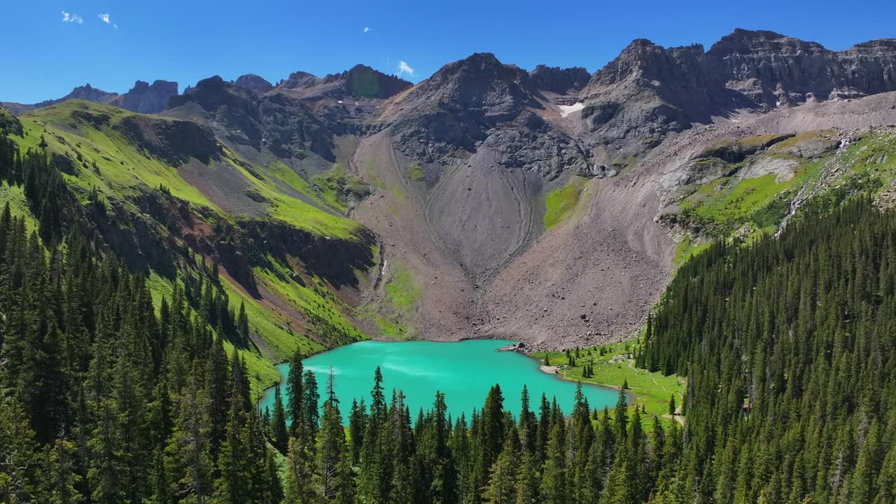 Mount Sneffels Wilderness Lower Ice Blue Lake beautiful sunny morning Ridgway Telluride Colorado aerial drone San Juan Rocky Mountains Uncompahgre National Forest Dallas Range blue sky forward pan up