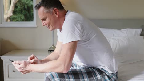 man using mobile in bedroom at home 4k