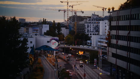 Golden-hour-dusk-light-on-Spittelau-Vienna-Austria-as-cars-drive-below-road-intersection