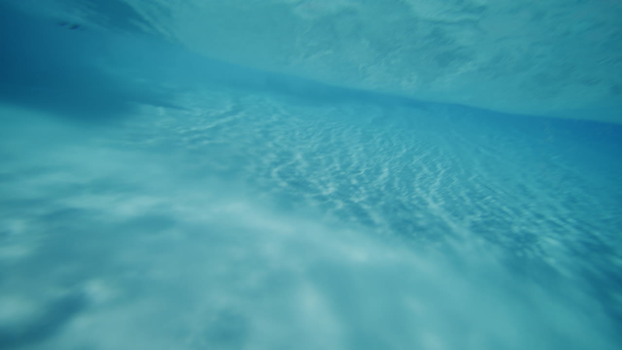 Slow motion wave pool shot with water ripples and light reflections