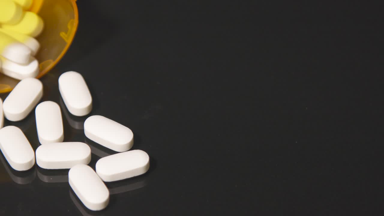 opioid white pills for health addiction pain medicine black table