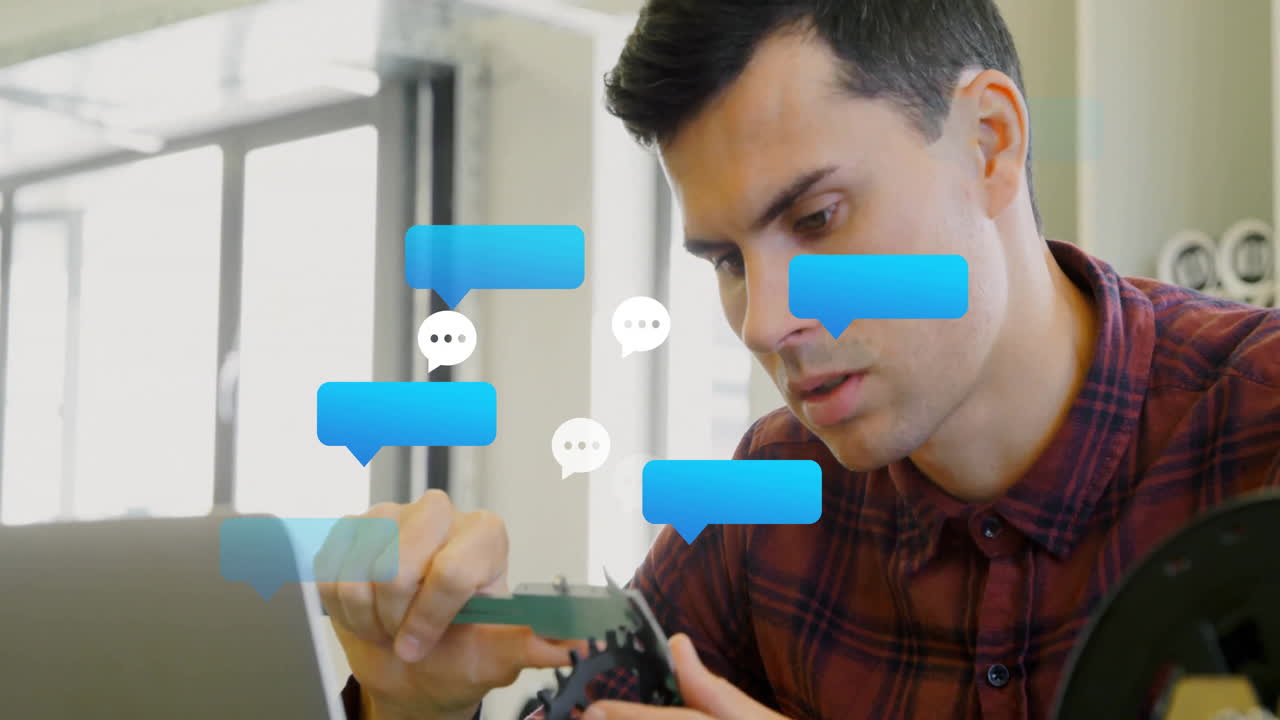 Engineer using digital calipers measuring gear in tech workshop, featuring chat bubbles