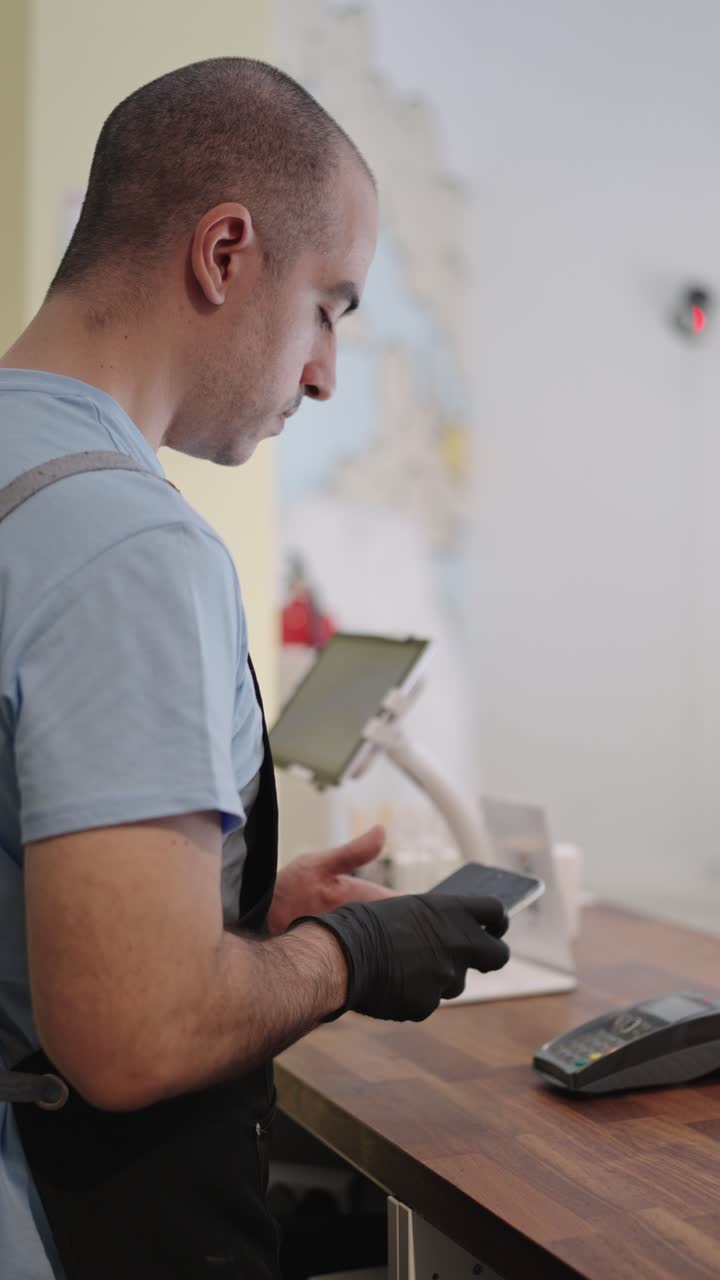 Man using a tablet at a cash register