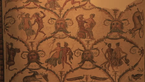 ancient mosaic art with mythological figures and intricate patterns displayed on a wall