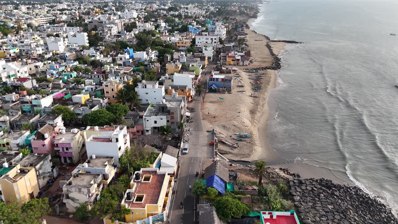 Long coastline framed by colorful rooftops and lush greenery in urban Pondicherry