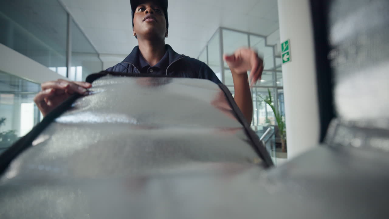 A woman delivers pizza to an office