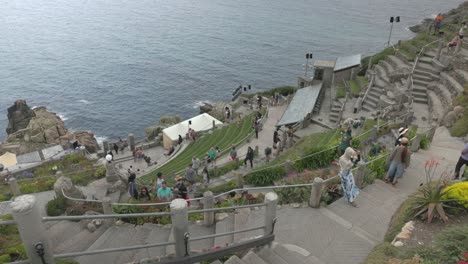 the minack theatre, an outdoor cliffside amphitheater overlooking the ocean in cornwall