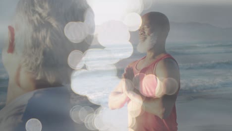 animación de manchas brillantes sobre una feliz pareja de ancianos afroamericanos practicando yoga en la playa