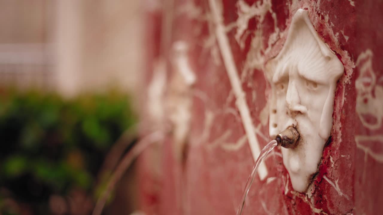 Ornate Marble Fountain in Valencia Spraying Fresh Water Through Carved Faces