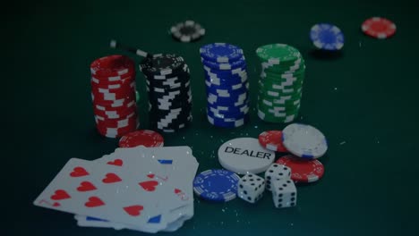 Animation-of-confetti-and-poker-chips-falling-onto-stacks,-dice-and-playing-cards-on-gambling-table