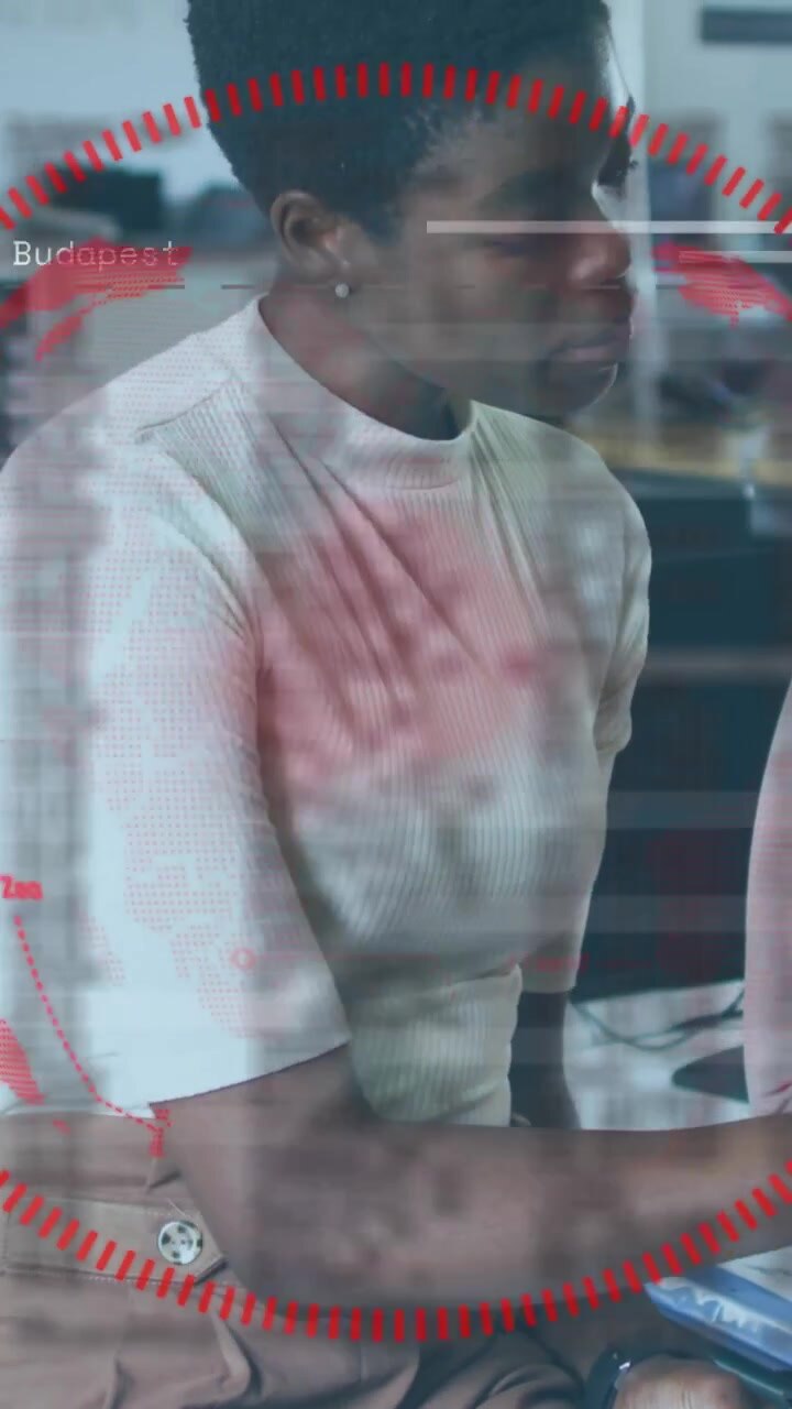 Vertical video: Reacting to red HUD desk worker in ribbed top tan pants typing laptop with coworker