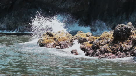 Slow-motion-static-clip-of-ocean-waves-crashing-against-rocky-Hawaiian-coast