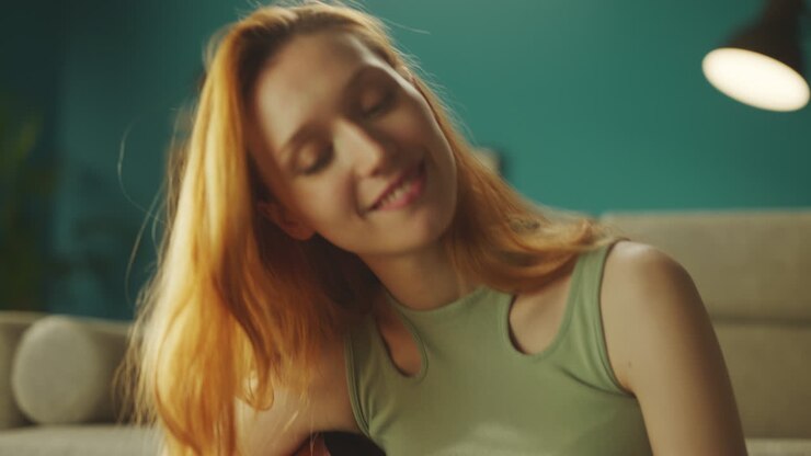 Girl playing guitar in room