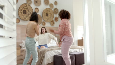 dancing and having fun, three diverse women friends enjoying time together in bedroom
