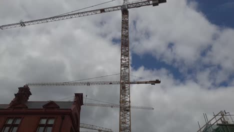 planning upwards shot of some building work in the heart of dublin, cranes and old buildings