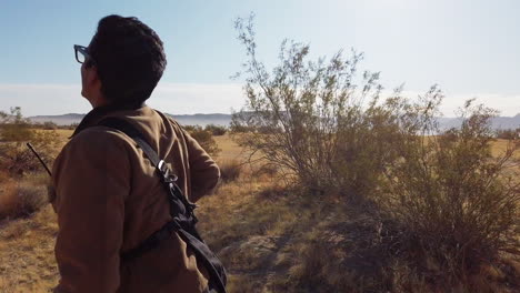 drone pilot running and trying to save drone crashing in desert