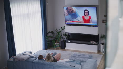 family watching news on tv in a modern living room