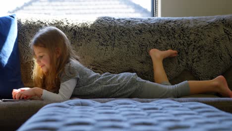 girl holding digital tablet in living room 4k