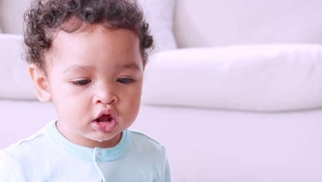 black toddler playing xylophone with his mum in sitting room