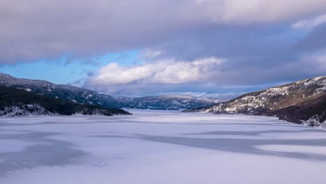 A-beautiful-view-of-fast-moving-clouds-over-the-frozen-fjord-between-the-mountains