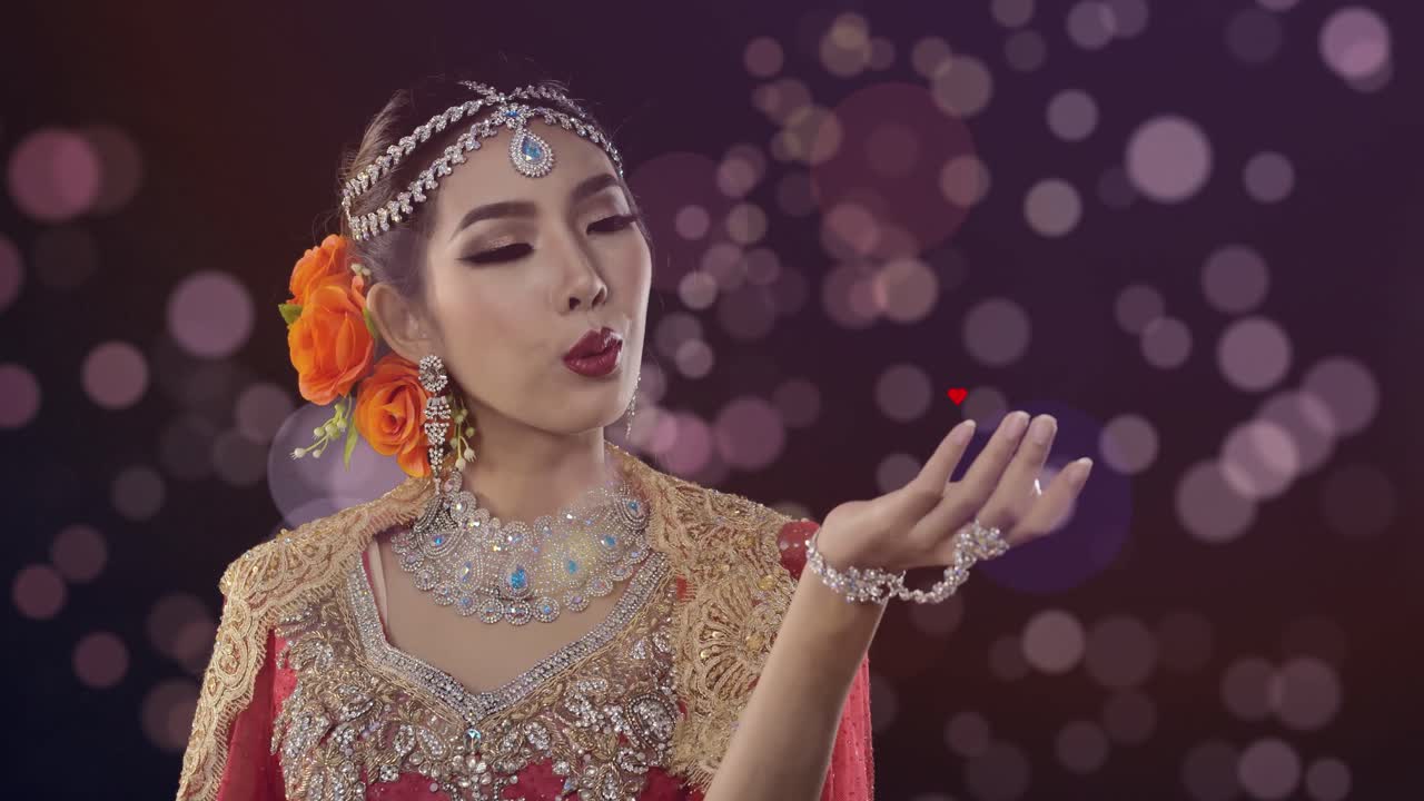 Stunning woman in traditional Indian dress blows a heart to her lover which is pierced by Cupid's arrow and grows in love in flight