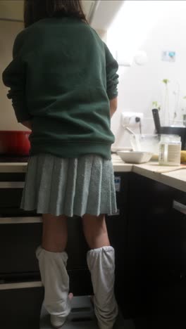 child cooking in kitchen