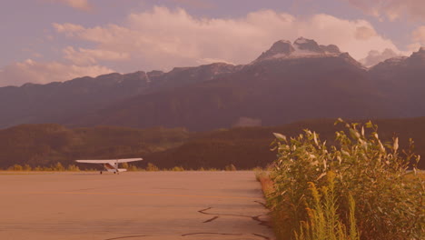 view of an airplane landing on the runway at an airport