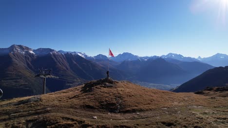 captivating outlook to panoramic matterhorn and alps with hiker and swiss flag