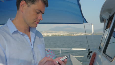 man using smart phone on the yacht