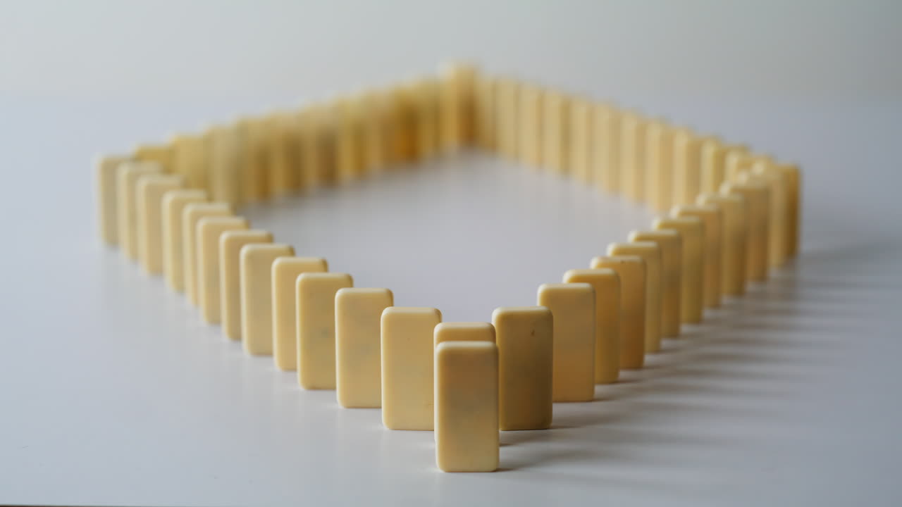 Lines dominoes arranged figure diamond on surface closeup. Rectangular blocks