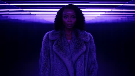 woman in fur coat with purple lighting