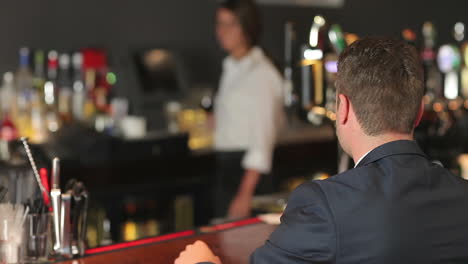 businessman ordering glass of red wine