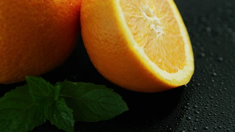 sliced orange with green leaves