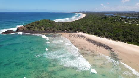 turquoise ocean at fingal head beach in new south wales, australia - aerial drone shot