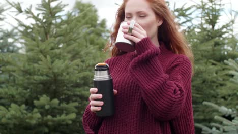 tourist drinking coffee in forest